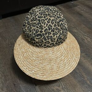 August brand hat featuring a leopard print crown and a wide‎ brim made of straw